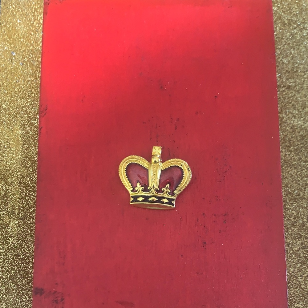 Gold Crown Brooch on Red Background